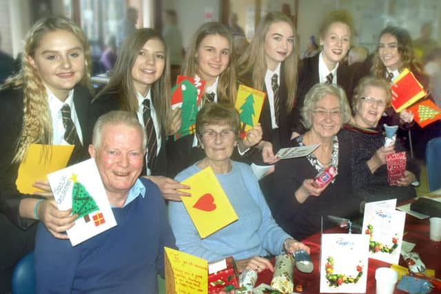 John Ferneley students hand out presents and cards at the Gloucester House Christmas party PHOTO: Tim Williams