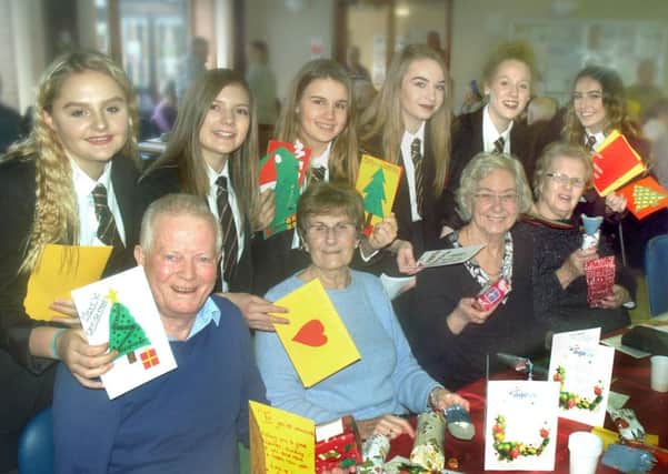 John Ferneley students hand out presents and cards at the Gloucester House Christmas party PHOTO: Tim Williams
