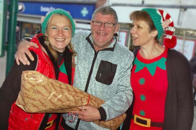 Simon Canham gets a present wrapped by Melton's finest elves Lisa Brown and Shelagh Core PHOTO: Tim Williams