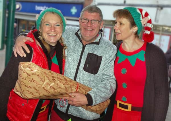 Simon Canham gets a present wrapped by Melton's finest elves Lisa Brown and Shelagh Core PHOTO: Tim Williams