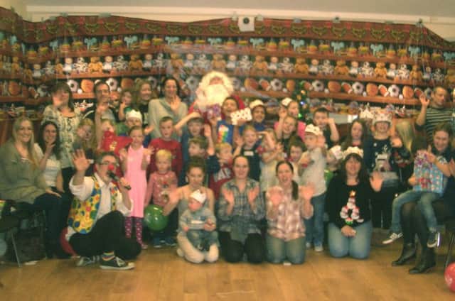 Entertainer Neil Rabjohn with some of the children at their Christmas party PHOTO: Supplied