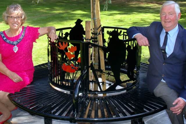 Melton Town Estate feoffee John Southerington and Senior Townwarden Dinah Rudman sit on the new commemorative seat in the town's Memorial Gardens EMN-161228-095202001