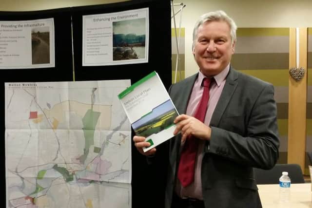 Jim Worley, Melton Council's head of regulatory services, hold a copy of Melton's draft Local Plan document