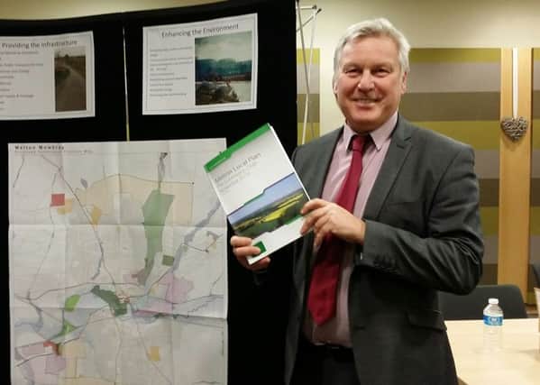 Jim Worley, Melton Council's head of regulatory services, hold a copy of Melton's draft Local Plan document