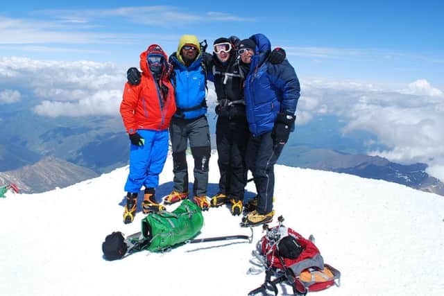 Chris Foster (right), of Long Clawson, with three team members at the summit of Mount Elbrus in Russia, Europe's tallest peak.
Photo supplied EMN-161228-131410001