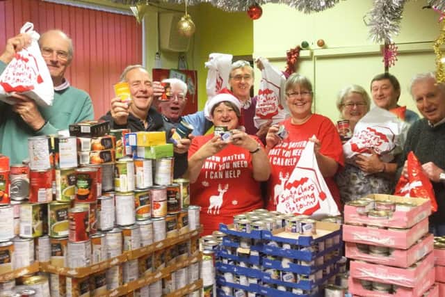 Members of the Melton Lions and Melton's Rotary clubs with some of the donated food PHOTO: Supplied