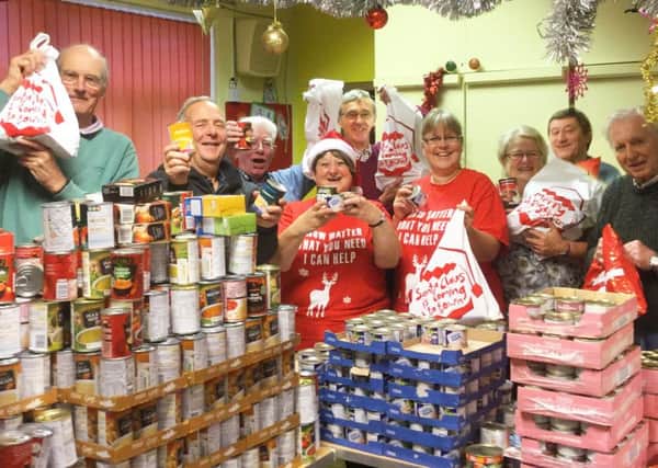 Members of the Melton Lions and Melton's Rotary clubs with some of the donated food PHOTO: Supplied