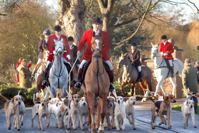 Hounds and riders are led away from the park on the way to Saxby Road during Monday's New Year hunt meet in Melton EMN-170301-120221001