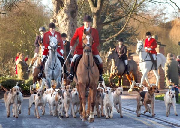 Hounds and riders are led away from the park on the way to Saxby Road during Monday's New Year hunt meet in Melton EMN-170301-120221001
