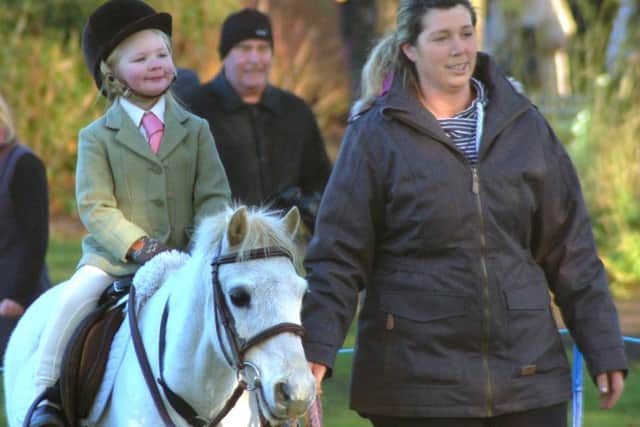 Four-year-old Maisie Brown rides her pony Bobby with mum Melissa at the traditional New Year hunt meet in Melton this week EMN-170301-120158001