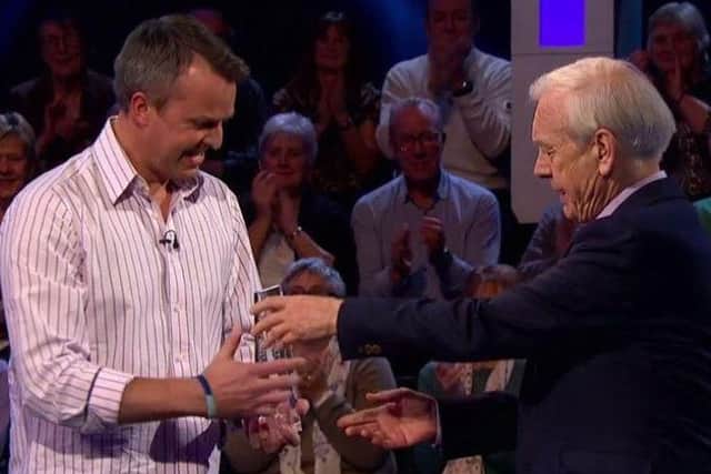 Graeme Swann is pictured receiving his Celebrity Mastermind trophy from presenter John Humphrys PHOTO: BBC Pictures