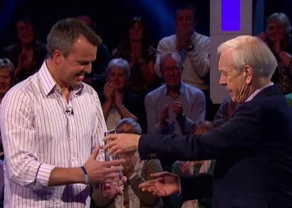 Graeme Swann is pictured receiving his Celebrity Mastermind trophy from presenter John Humphrys PHOTO: BBC Pictures
