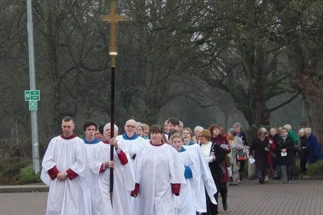 Members of St Mary's Church, Melton, take part in a procession to their new temporary venue for Sunday services at the Melton Council offices EMN-170901-122355001