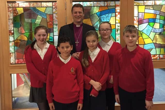 Bishop Martyn Snow with Queniborough School pupils PHOTO: Supplied