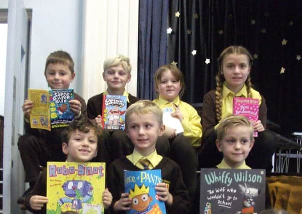 Children at St Francis show off their books given to them by the school's book elf PHOTO: Supplied