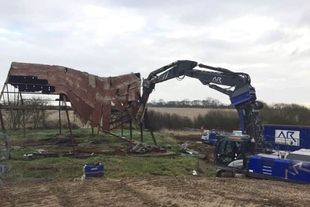 Workmen demolish a derelict aircraft hanger at Burrough Court Estate to make way for the Matt Hampson Foundation's Get Busy Living Centre EMN-170118-154127001