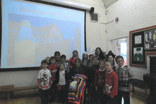 Irene Parker with some of the pupils from Great Dalby Primary School PHOTO: Supplied