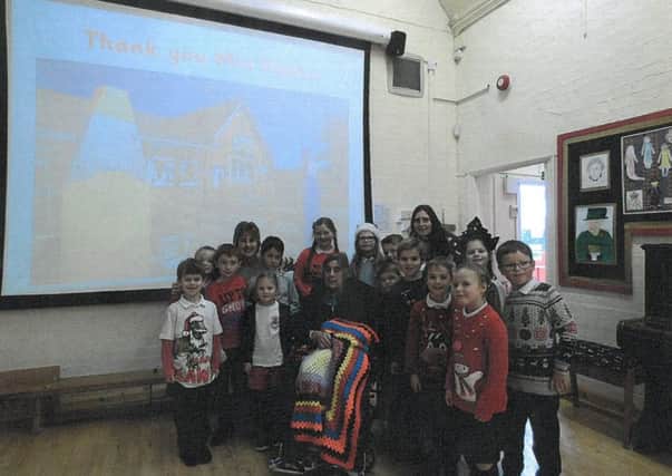 Irene Parker with some of the pupils from Great Dalby Primary School PHOTO: Supplied