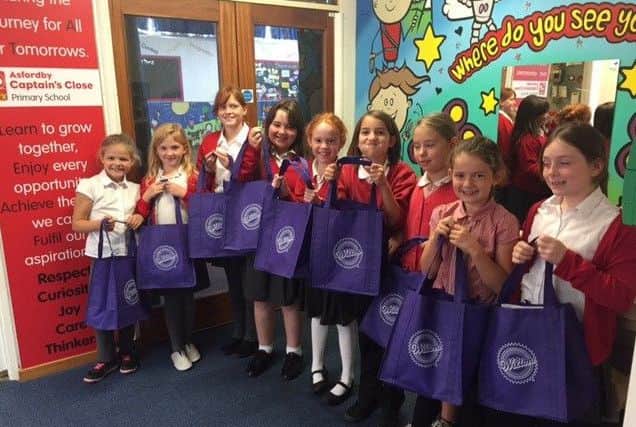 The girls show off their Wilton baking bags after taking part in the school bake-off challenge PHOTO: Supplied
