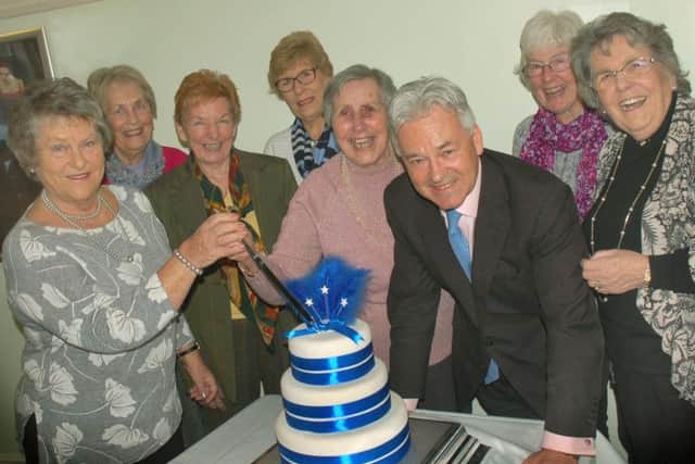 92-year-old Doris Packenham-Walsh cuts the cake with Sir Alan Duncan and Conservative Ladies Luncheon Club members PHOTO: Tim Williams