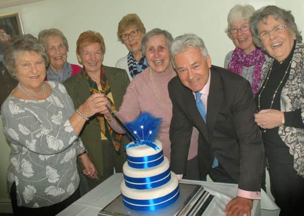92-year-old Doris Packenham-Walsh cuts the cake with Sir Alan Duncan and Conservative Ladies Luncheon Club members PHOTO: Tim Williams
