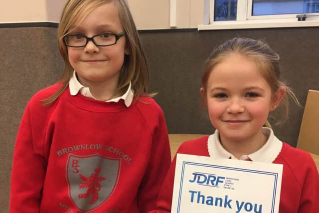 Sam with Lucy holding her certificate of thanks from JDRF PHOTO: Supplied