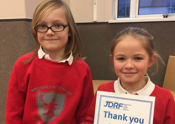 Sam with Lucy holding her certificate of thanks from JDRF PHOTO: Supplied