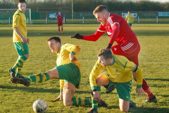 Ian Bitmead and Aatron Ridout double up on Stapenhill dangerman Steve Hart who scored his 42nd goal of the season at Welby Road EMN-170802-101058002