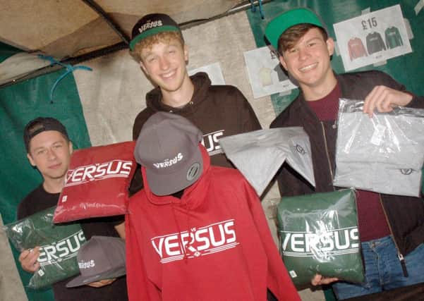Versus co-owner Joe Twelvetree and friends Nathan Cridland and Matthew Creighton on their stall PHOTO: Tim Williams