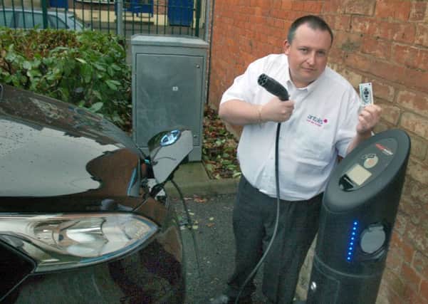 Electric car driver Andrew Musson attempts to power his vehicle in Melton's Burton Street car park at a charging point which has remained out of commission since being installed by Melton Council three years ago. EMN-170702-162102001