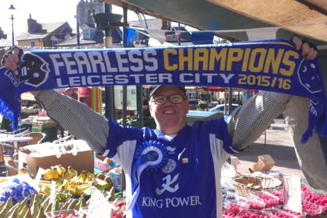 Melton Market stallholder and Leicester City fan Lennie Greet celebrates the Foxes winning the Premier League EMN-170902-104059002