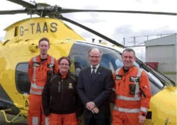 Martin Reason, chief executive of Melton Mowbray Building Society, pictured with crew members of the Derbyshire, Leicestershire and Rutland Air Ambulance (DLRAA) after donating nearly Â£9,000 to it EMN-170213-120945001