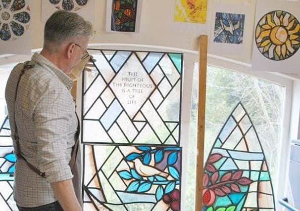 Stained glass artist Derek Hunt inspects the progress of the window he is making for St Mary's Church in Melton as part of its Â£1.9 million Re-Ordering Project EMN-170217-111137001