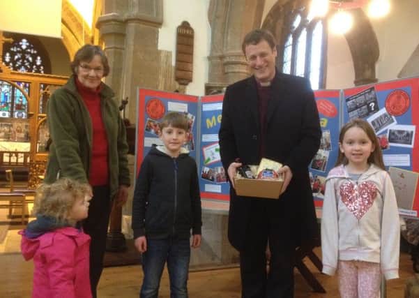 Bishop Martyn receives his small hamper of local goodies 
PHOTO: Supplied