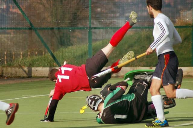 Andy Sibun, who teed up Meltons equaliser, is sent flying EMN-170221-114118002