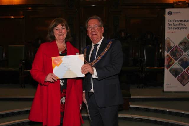 Chris Gatfield from Dove Cottage (left) receives award from David Hagger (right) PHOTO: Andy Greeen