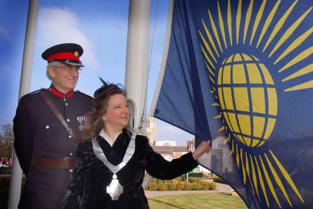 Former Mayor of Melton Jeanne Douglas raises the Commonwealth Flag in 2016 assisted by ex-Deputy Lieutenant of Leicestershire David Wyrko QPM DL PHOTO: Tim Williams