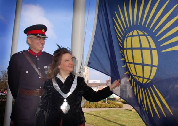 Former Mayor of Melton Jeanne Douglas raises the Commonwealth Flag in 2016 assisted by ex-Deputy Lieutenant of Leicestershire David Wyrko QPM DL PHOTO: Tim Williams