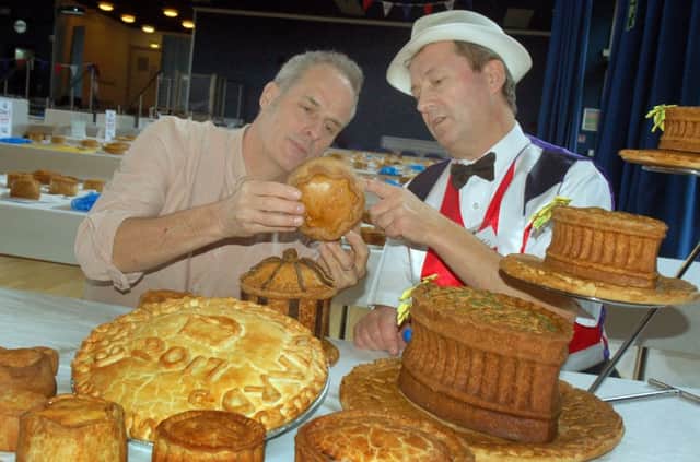 TV chef Phil Vickery (left) inspects the pork pies with Stephen Hallam, of Melton's Dickinson and Morris Ye Olde Pork Pie Shoppe, at the judging for the British Pie Awards EMN-170803-135644001