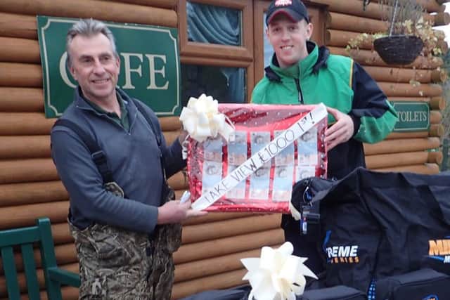 Lake View owner Richard Turner hands over the Â£1,000 prize to Aaron Morton EMN-170314-191703002