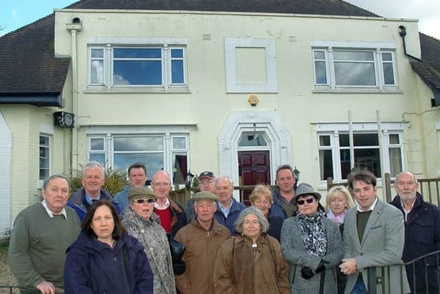 Melton borough councillor Leigh Higgins outside The Fox Inn at Thorpe Satchville and villagers who want to see it reopen as a viable business EMN-170322-145520001
