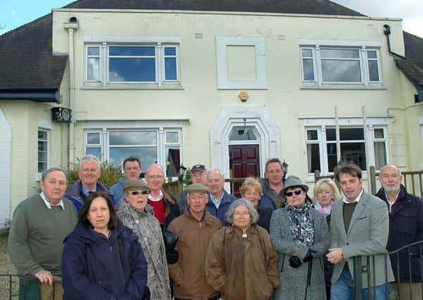 Melton borough councillor Leigh Higgins outside The Fox Inn at Thorpe Satchville and villagers who want to see it reopen as a viable business EMN-170322-145520001
