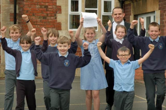 Head teacher Matthew Lee celebrates with members of the School Council PHOTO: Tim Williams