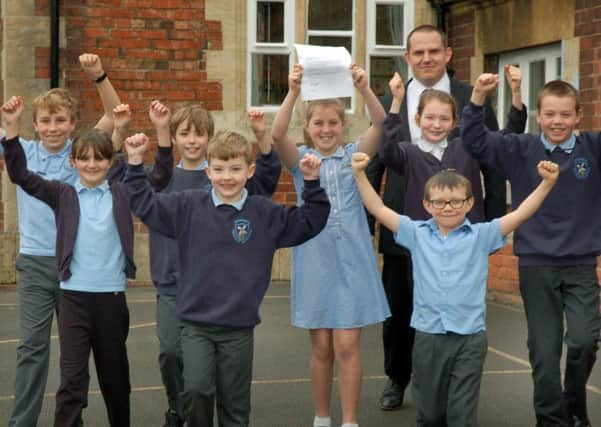 Head teacher Matthew Lee celebrates with members of the School Council PHOTO: Tim Williams