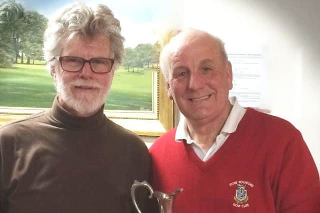 Seniors Captain Jim Price presents the Winter Warmers Trophy to Phil White (right) EMN-170328-125125002