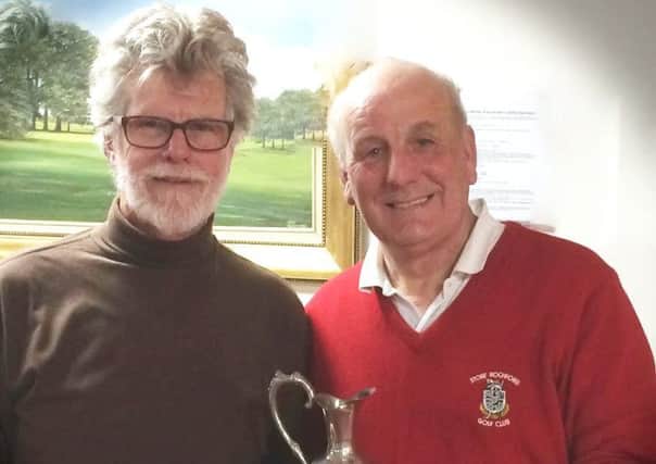 Seniors Captain Jim Price presents the Winter Warmers Trophy to Phil White (right) EMN-170328-125125002