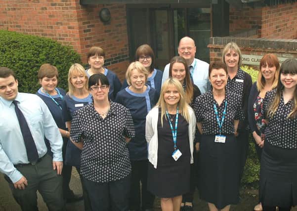 Group practice manager Sue Timberlake, staff members and GPs celebrate their high patient satisfaction ratings in the latest NHS survey EMN-170404-173217001