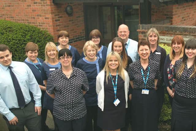 Group practice manager Sue Timberlake, staff members and GPs celebrate their high patient satisfaction ratings in the latest NHS survey EMN-170404-173217001