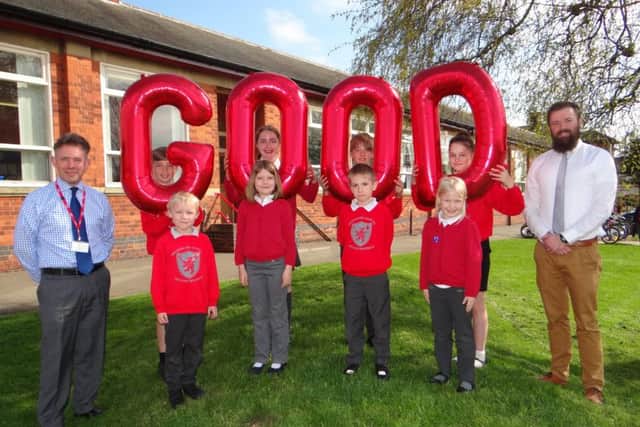 Pupils at Brownlow Primary School in Melton celebrate the school's 'good' Ofsetd rating with headteacher Damien Turrell (left) and deputy head Steve Nash EMN-170704-121210001