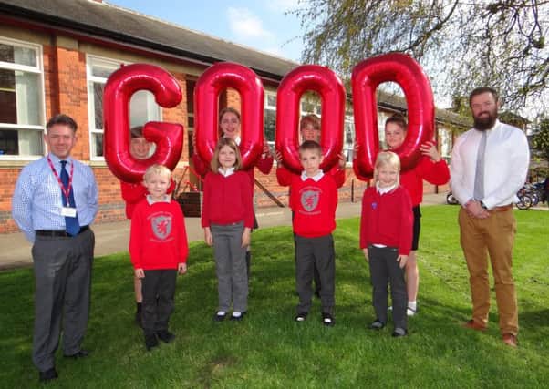 Pupils at Brownlow Primary School in Melton celebrate the school's 'good' Ofsetd rating with headteacher Damien Turrell (left) and deputy head Steve Nash EMN-170704-121210001